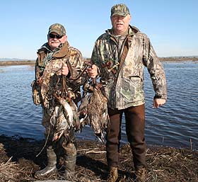 Father and son team of Dwight and Don  Reeve with their limits of ducks.